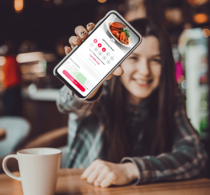 young girl in coffee shop wearing flannel shirt holding a mobile phone displaying the flex rewards digital punch card app