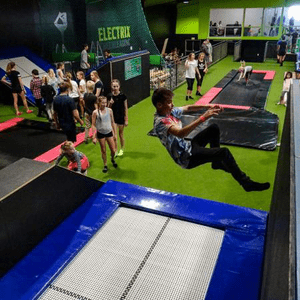 boy jumping off a wall at indoor trampoline park