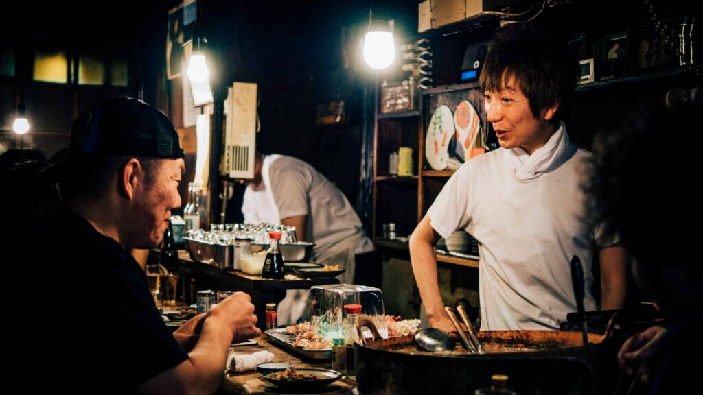 chef talking to customer in Japanese restaurant